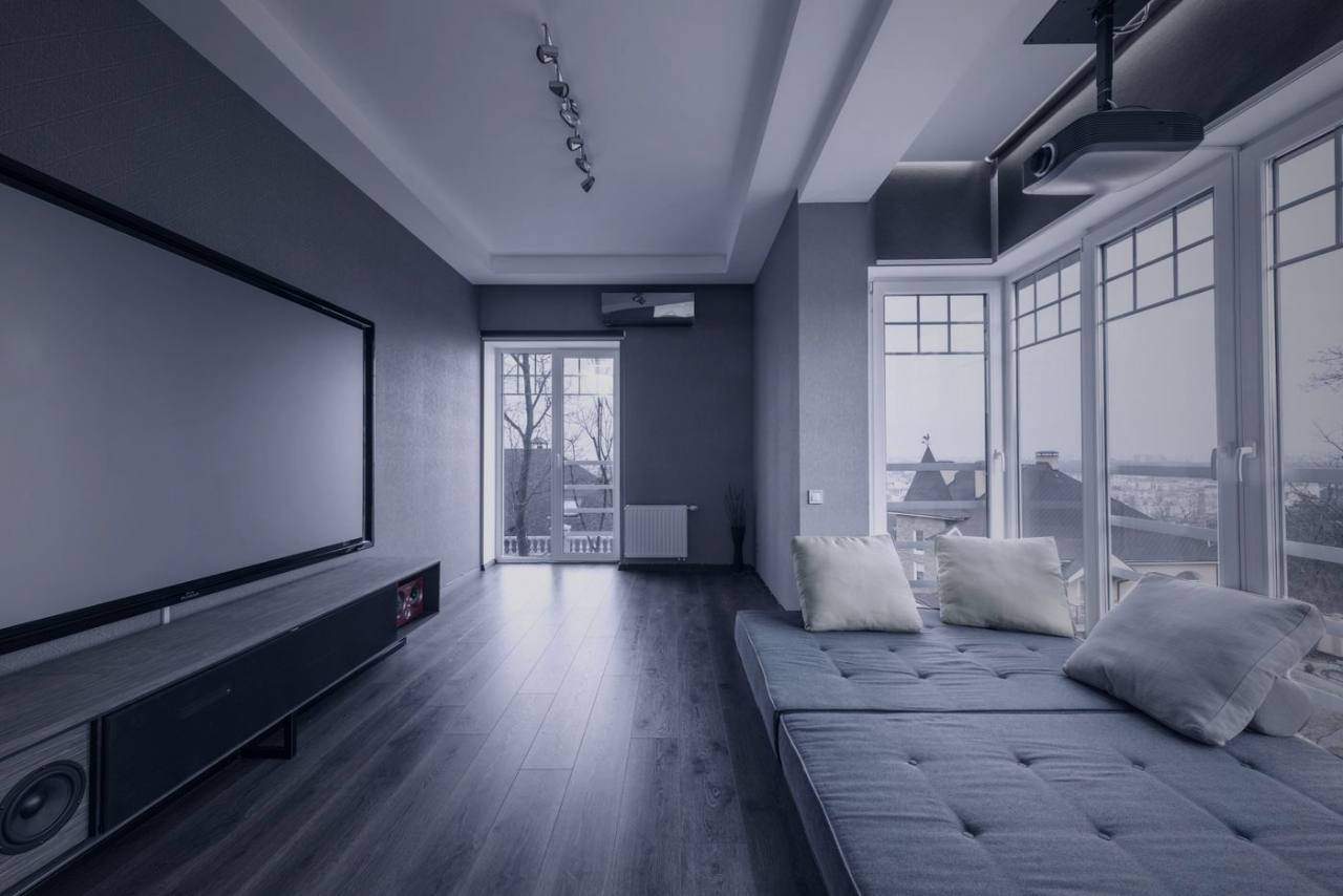 Living room with projection screen, ceiling projector and speakers
